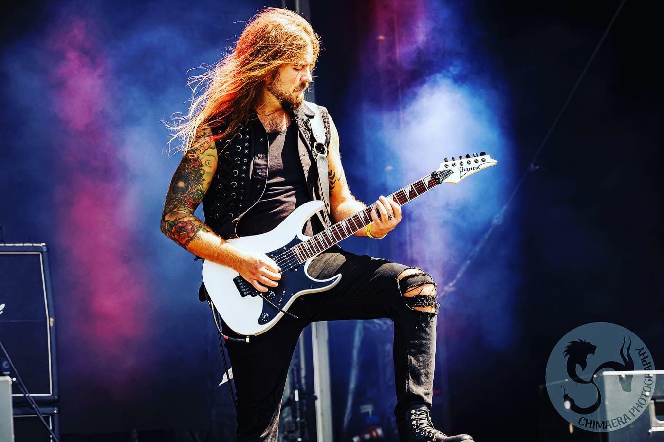Eric Juris performing lead guitar live on stage with Warlord